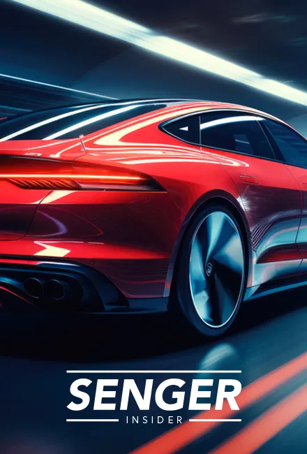 Ein rotes Sportauto fährt schnell durch einen beleuchteten Tunnel